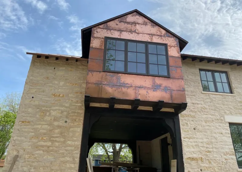 Copper metal panel facade on a stone building for Skylight Installation in Belton