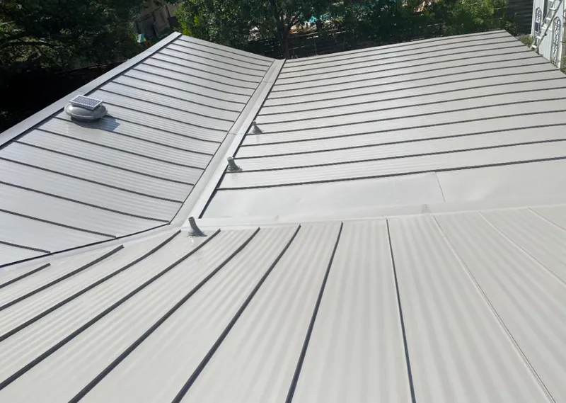 Solar attic fan installed on a metal roof for Roof Ventilation in Belton